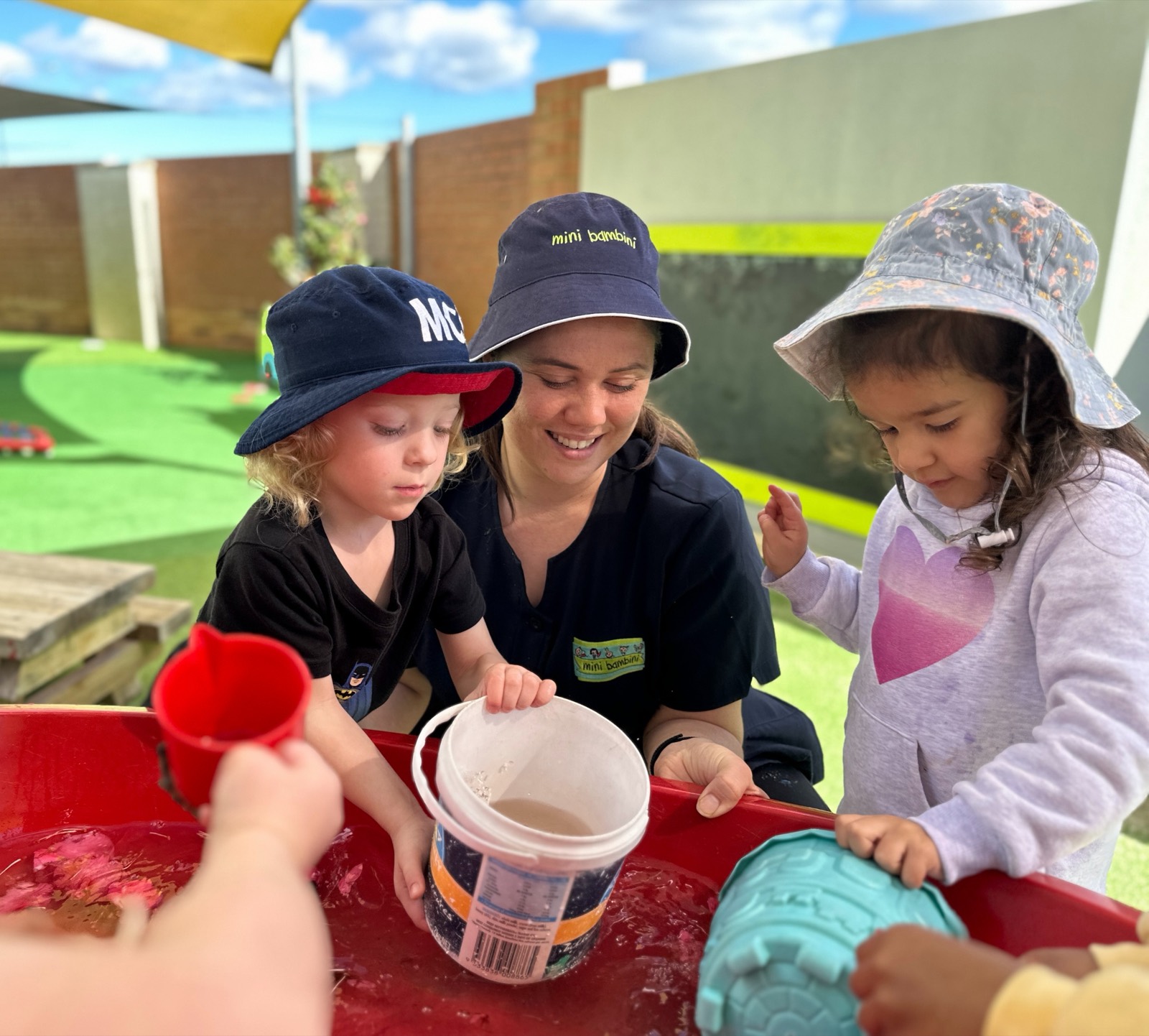 Children at a table during an indoor activity at Mini Bambini